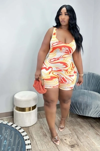 Detail of plus size sleeveless romper with vibrant orange and yellow abstract digital print