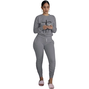 Detail of grey lounge set with Faith cross print and gathered hem joggers on white background