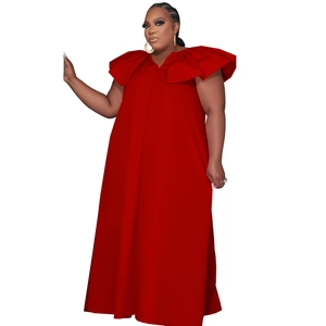 Detail of red maxi dress featuring ruffled sleeves and a deep V-neckline in premium fabric
