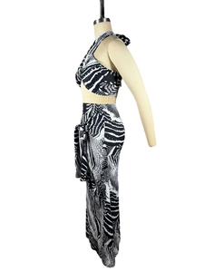 Detail view of black and white zebra print two-piece set with wrap top and side-tie skirt