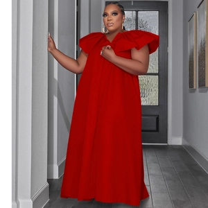 Detail of red plus size maxi dress featuring tiered ruffles and elegant V-neckline