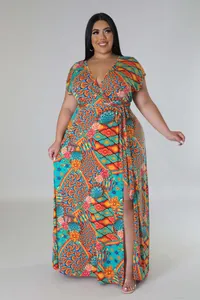 Detail of plus size maxi dress featuring vibrant geometric floral prints and side slit
