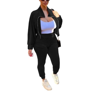 Detailed view of women's black velvet tracksuit set with zip jacket and pocket pants