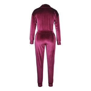 Detail of burgundy velvet tracksuit showing back seam design and ribbed cuffs
