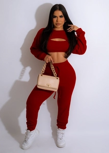 Detail view of red three-piece lounge set with ribbed knit texture and cropped cardigan