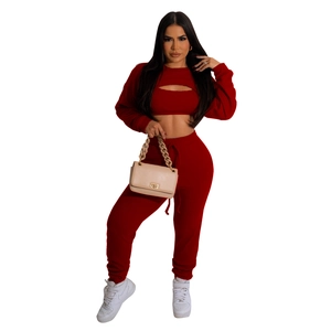 Close-up of wine red ribbed knit fabric on a trendy three-piece women's casual lounge set