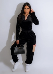 Detail view of premium black velvet tracksuit with striped collar and side pocket accents