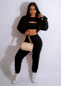 Detail of black ribbed knit lounge set featuring a cut-out crop top and drawstring joggers