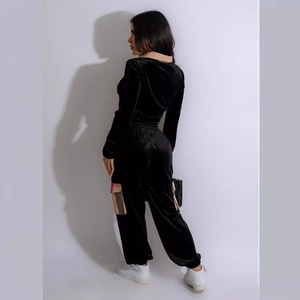 Women's velvet tracksuit set in black featuring long sleeves and plaid pocket trousers