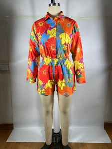 Detail of floral long sleeve button-up shirt and elastic shorts set in vibrant multi-colors