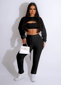 Detailed view of black three-piece ribbed knit lounge set with cropped bolero and drawstring pants
