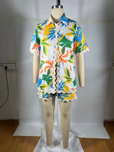 Detail of tropical floral print shirt set featuring unique scalloped wavy edge trimming