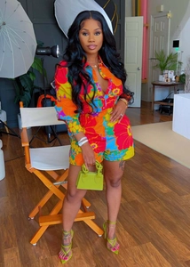 Detail of vibrant floral print long sleeve shirt and matching shorts set for women