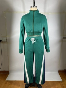 Detail of dark green tracksuit set featuring white contrast panels and drawstrings