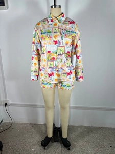 Detail of tropical palm print on long-sleeve shirt and matching shorts beach set