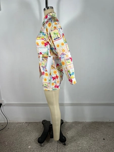 Detail of tropical beach print on white long sleeve shirt and shorts set for summer