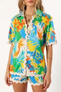 Detail showing scallop edge embroidery and vibrant tropical print on summer set