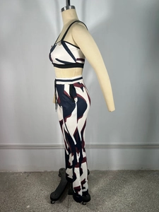 Side view of two-piece set featuring abstract print crop top and matching slim-fit trousers
