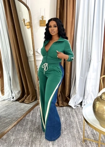 Detail of green two-piece tracksuit showing drawstring waist and white side stripes