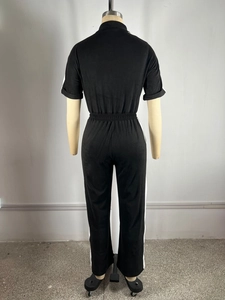 Back view of short sleeve jumpsuit featuring elastic waist and side contrast stripes