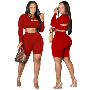 Three-piece vibrant red athletic set with cutout long sleeve top and high waist cycling shorts