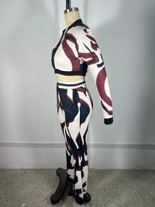 Close-up of women's marble print tracksuit featuring high-waisted pants and a cropped jacket