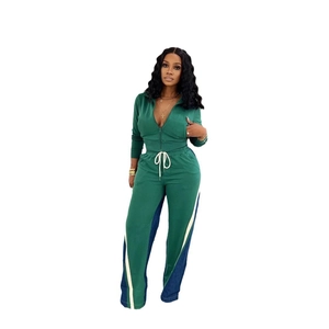 Green two-piece sport set featuring zip-up sweatshirt and wide-leg striped pants