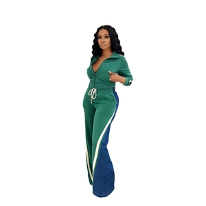 Detail of green athletic set featuring denim side panels and white vertical stripes