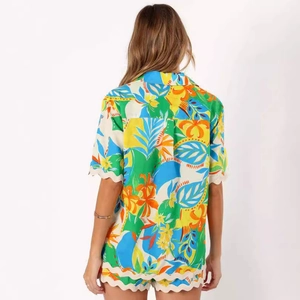 Back view of women's tropical floral two-piece set with scalloped edges and shorts