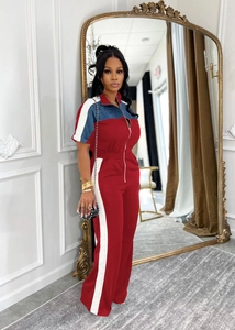 Detail of red short sleeve jumpsuit with denim color block and vertical side stripes