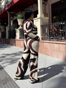 Detail view of knit two-piece set featuring abstract print crop top and wide leg pants
