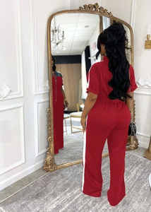 Detail of red and white patchwork zip-up jumpsuit with sporty side stripes