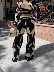 Detail of three-piece knit set featuring abstract geometric print with cardigan and pants