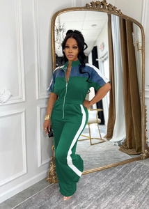 Detail of stand collar and front zipper on dark green denim patchwork jumpsuit