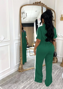 Detail of dark green tracksuit with white side stripes and stand collar on mirror view