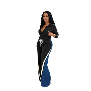 Detail of black sports set with side denim patchwork and white stripes on wide-leg pants