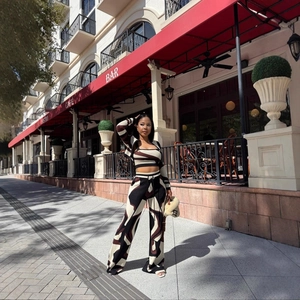 Three-piece knit set featuring abstract print cardigan, crop top, and wide-leg pants