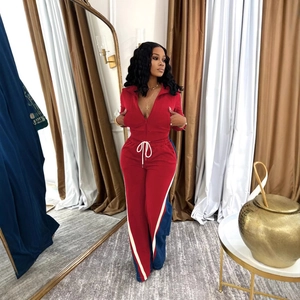 Women's 2-piece red tracksuit featuring a zip-up jacket and matching striped joggers