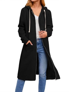 Detail view of the metal zipper and large pockets on a black longline hoodie