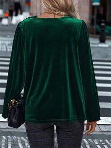 Street view of dark green velvet long sleeve top showing the loose back fit and soft texture