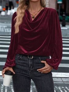 Close-up of deep wine red velvet blouse with elegant cowl neck and textured fabric