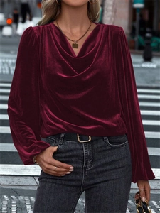 Detail of burgundy velvet top featuring an elegant cowl neck and lantern sleeves