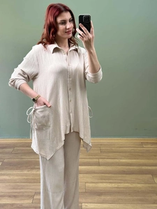 Detail of beige wrinkled texture fabric with adjustable side drawstring and pockets