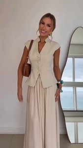 Detail of elegant beige vest and pleated chiffon skirt set with minimalist V-neck design