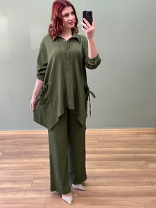 Detail view of olive green two-piece set featuring textured fabric and drawstring shirt