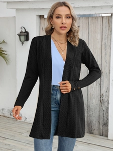Detail of black long cardigan featuring textured crinkle fabric and metal cuff buttons