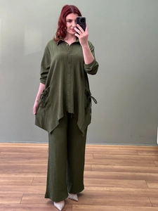 Detailed texture of olive green crinkle fabric on a loose two-piece long sleeve shirt set