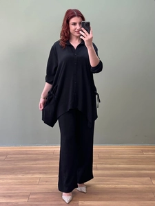 Women's black two-piece lounge set with pleated button-down shirt and wide-leg trousers