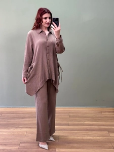Detail of mocha pleated set showing button-up collar and asymmetric drawstring hemline