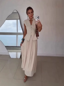 Elegant beige two-piece set featuring a tailored vest and high-waist maxi skirt